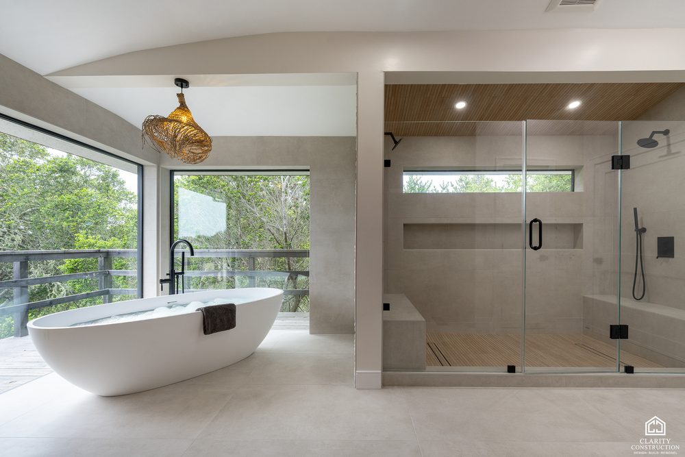 Hillside primary bathroom with a freestanding tub set against a floor to ceiling window