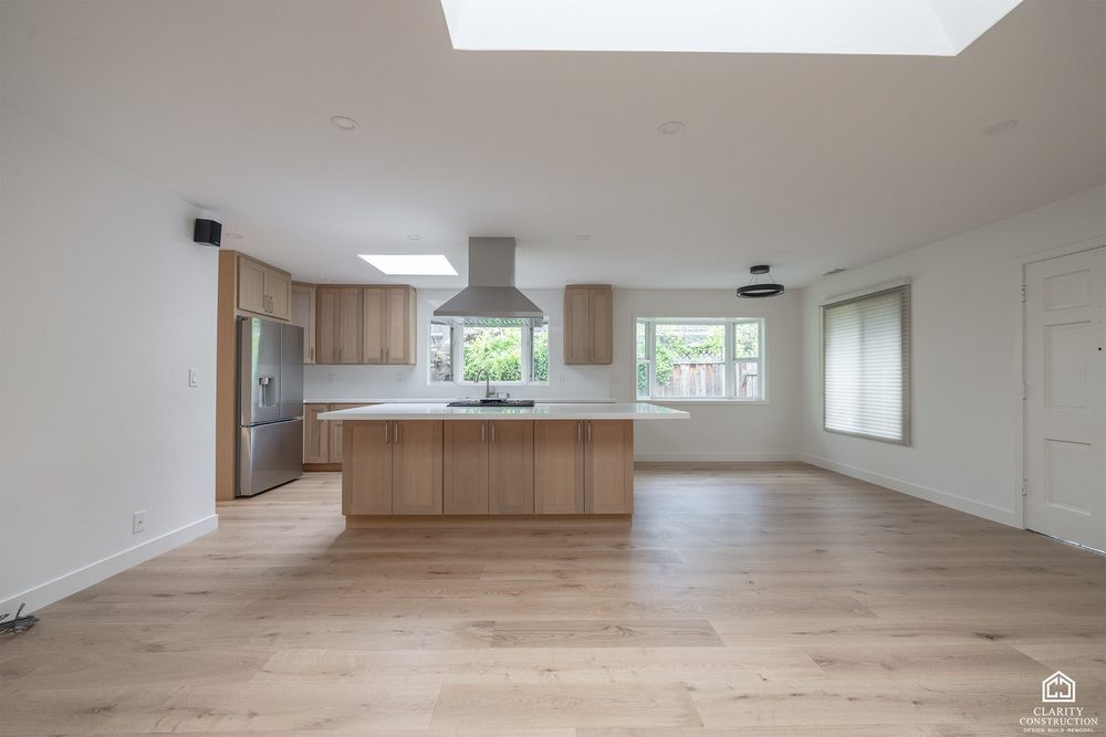 Open plan kitchen and living space after a whole home renovation, with new oak floors