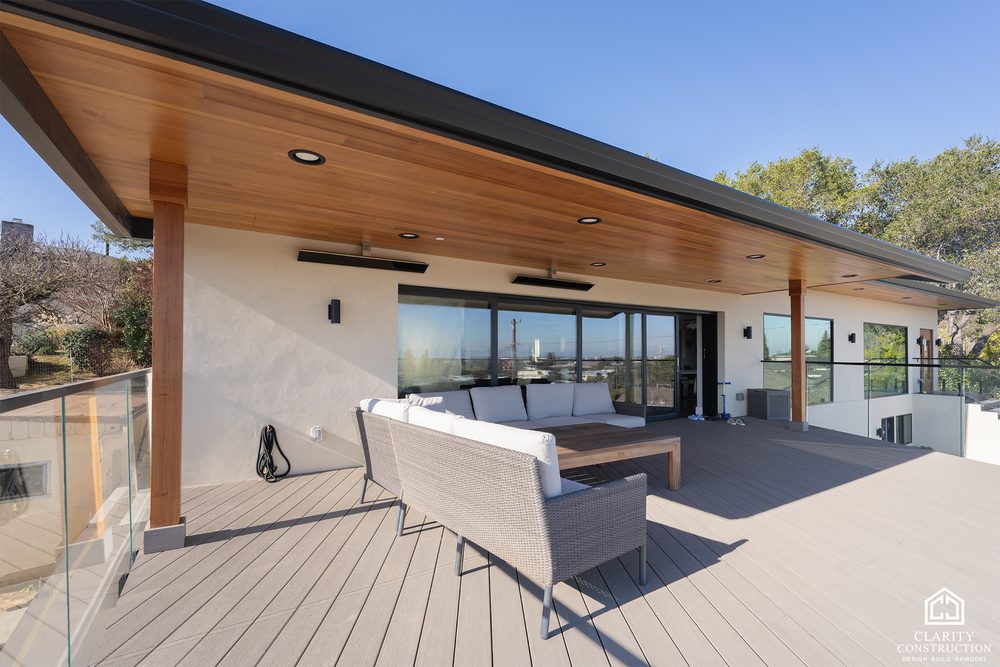 Outdoor sofa on a covered composite deck with a cedar ceiling and glass railing