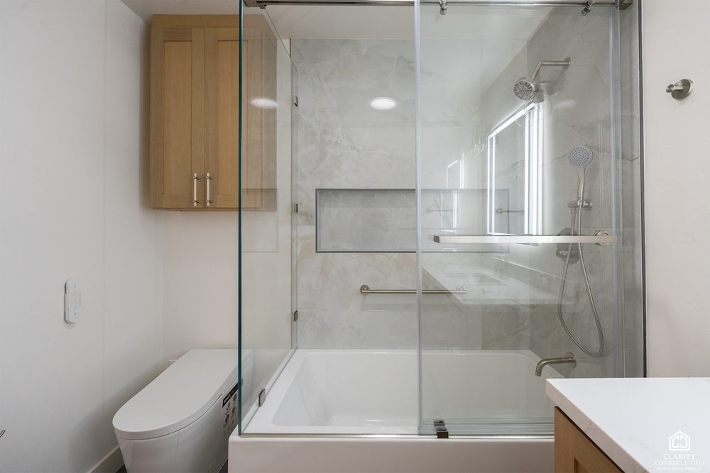 Tub and shower combination with large-format tile and a glass screen