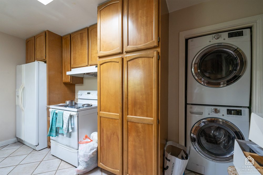 The original kitchen corner with a stacked washer and dryer