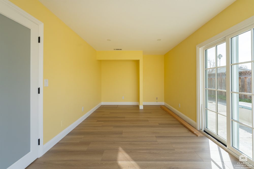 Living room with a skylight and French doors opening to the yard
