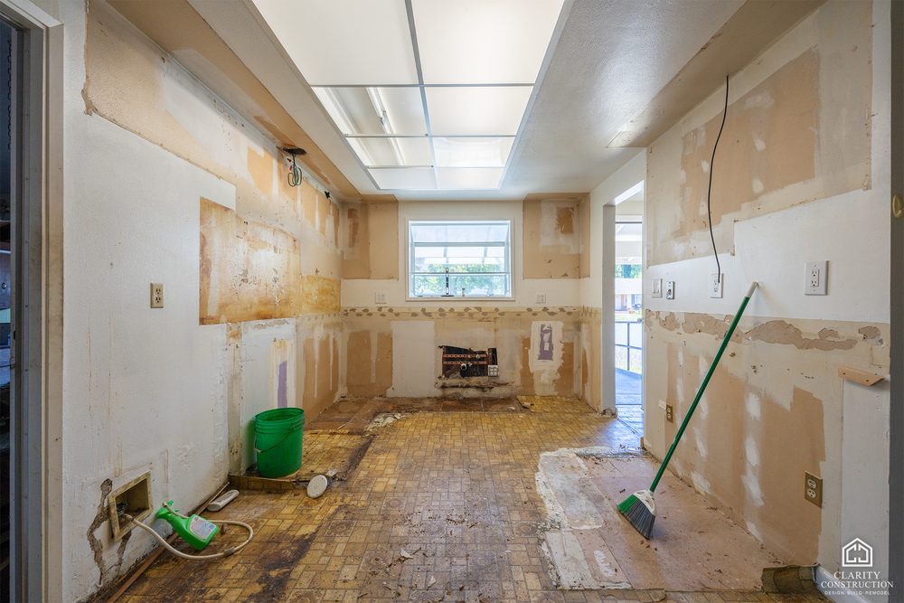 The living room stripped to bare drywall during demolition