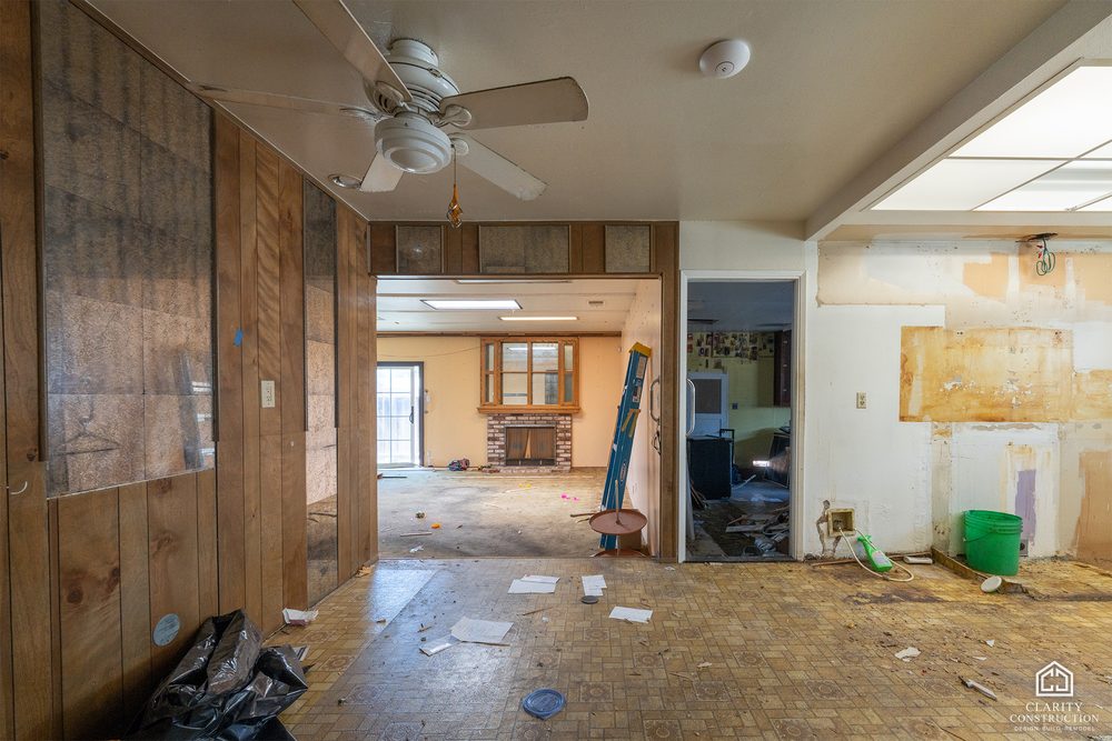The original wood-paneled living room before demolition