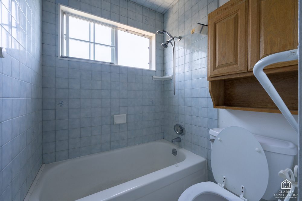 The original gray tile bathroom before demolition