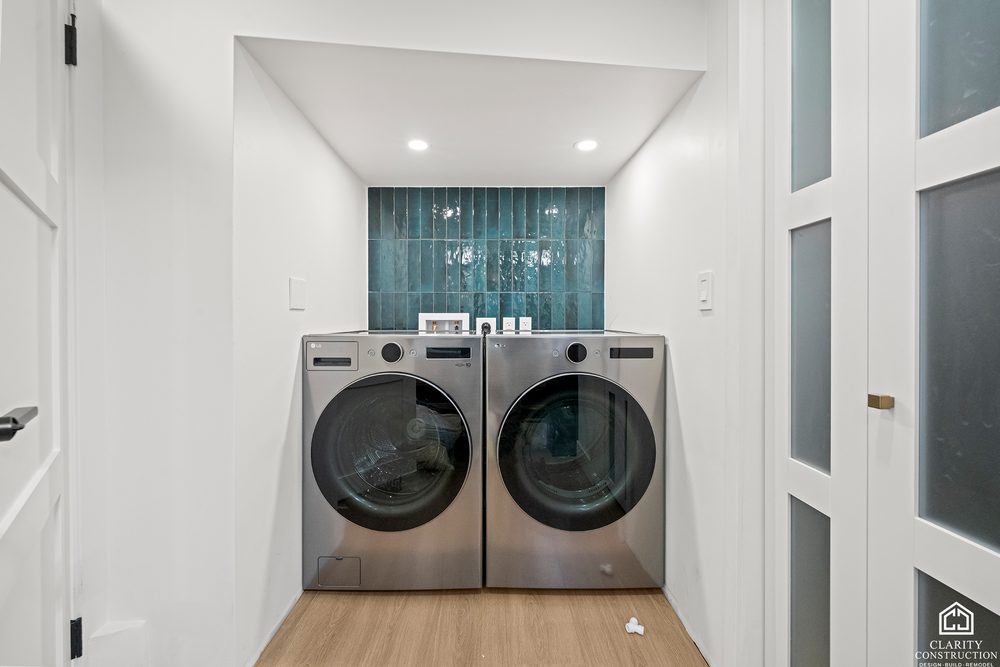 Laundry closet with a washer and dryer behind a glass door