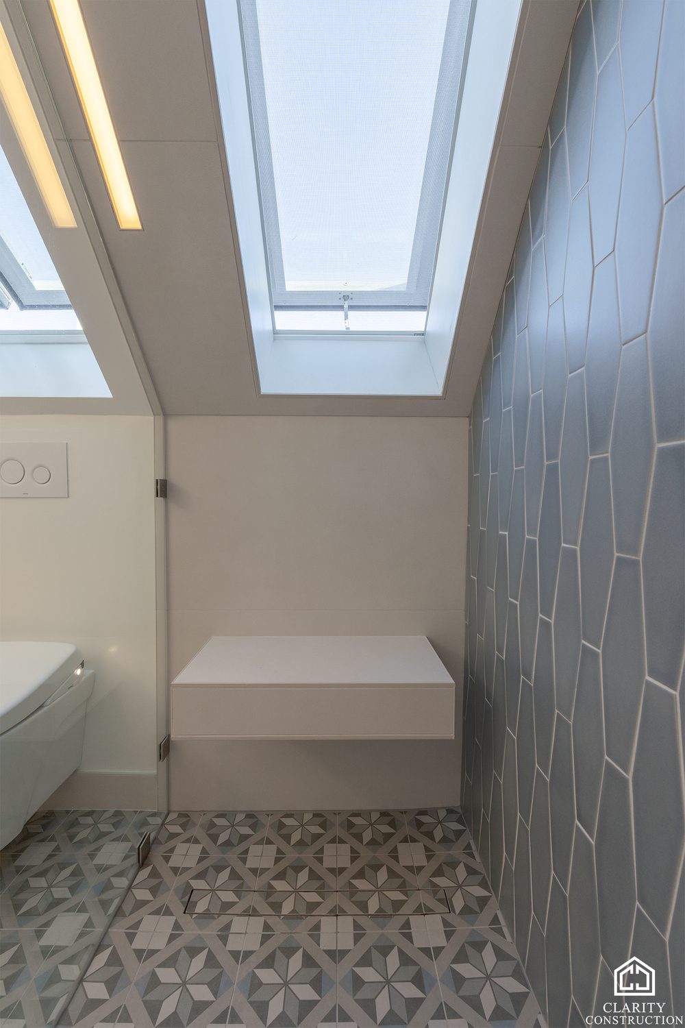 Two skylights over the tiled shower bench