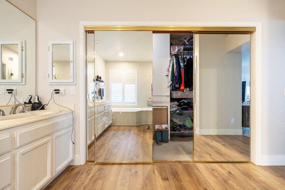 The original vanity and mirrored closet before the remodel