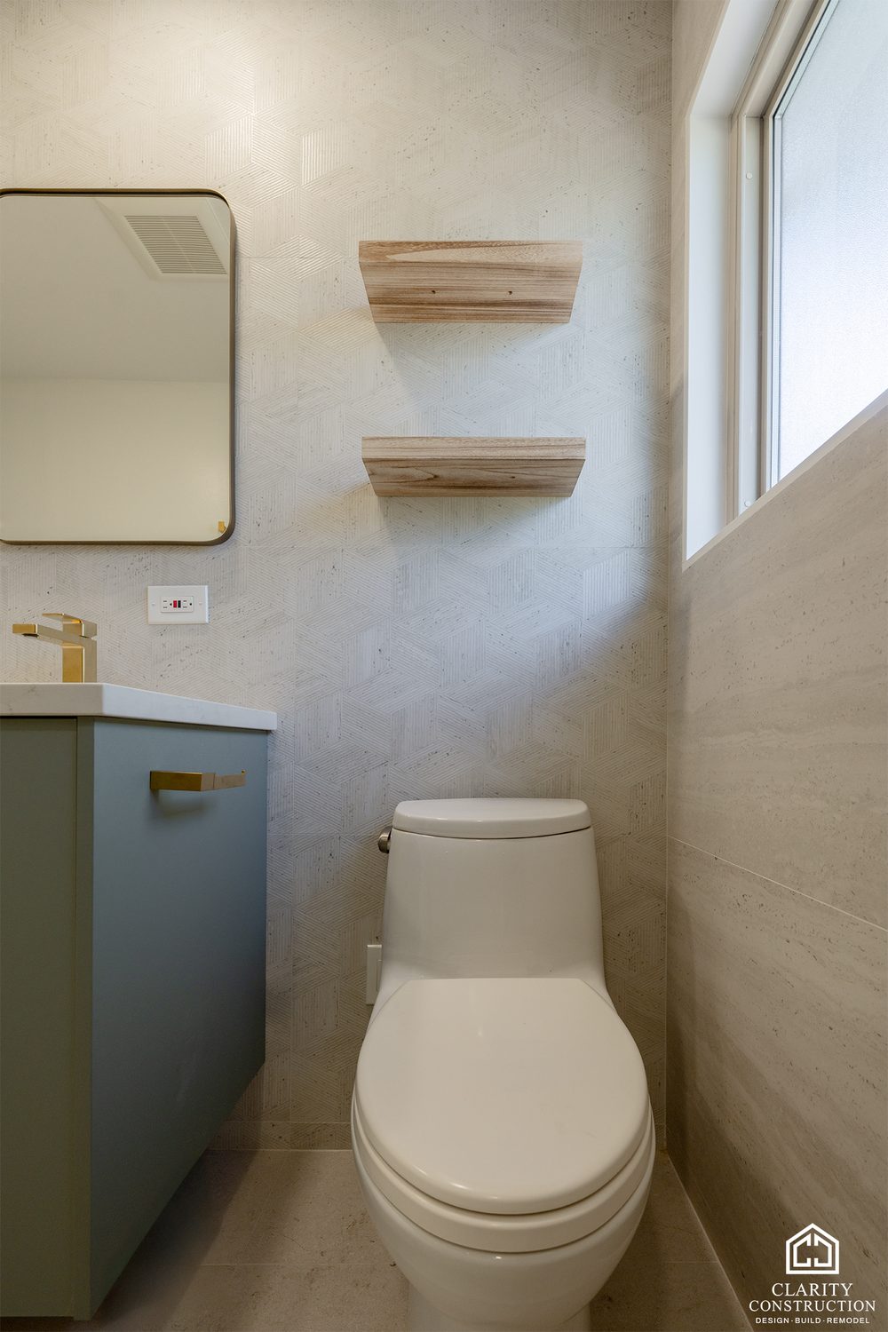 Floating wood shelves and a black-framed mirror beside the window