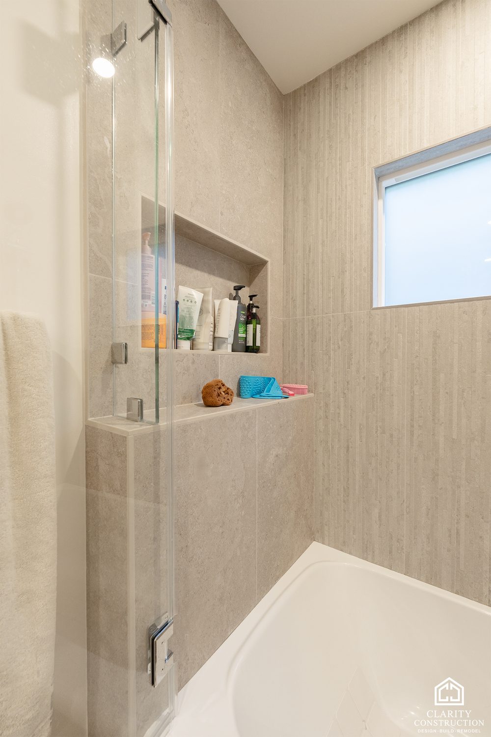 Recessed niche and hand shower in the tiled tub surround