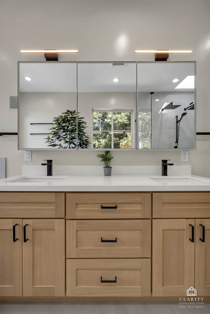 Double vanity with medicine-cabinet mirrors and black faucets