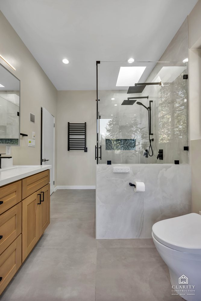 Shower, heated towel rail and toilet seen from the doorway