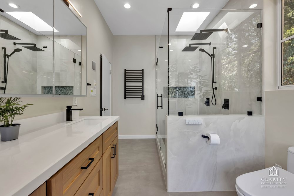 Double vanity, toilet and walk-in shower under the vaulted ceiling