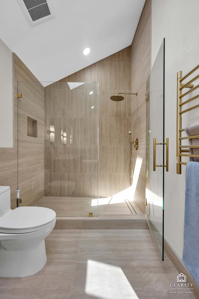 Primary bath: glass shower door and brass towel rail