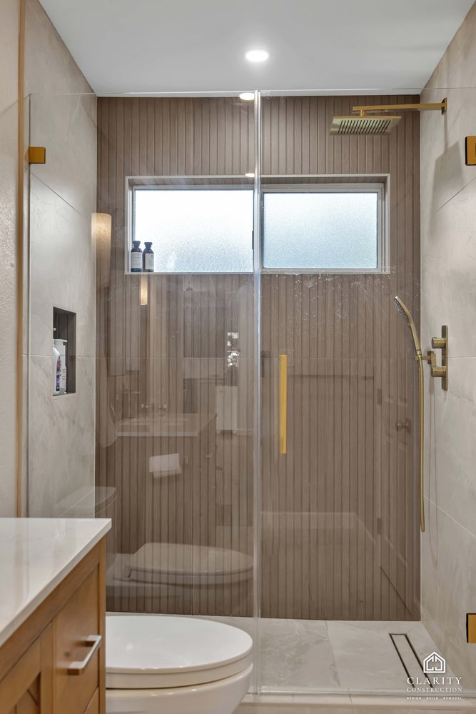 Hall bath: shower door with a brass handle