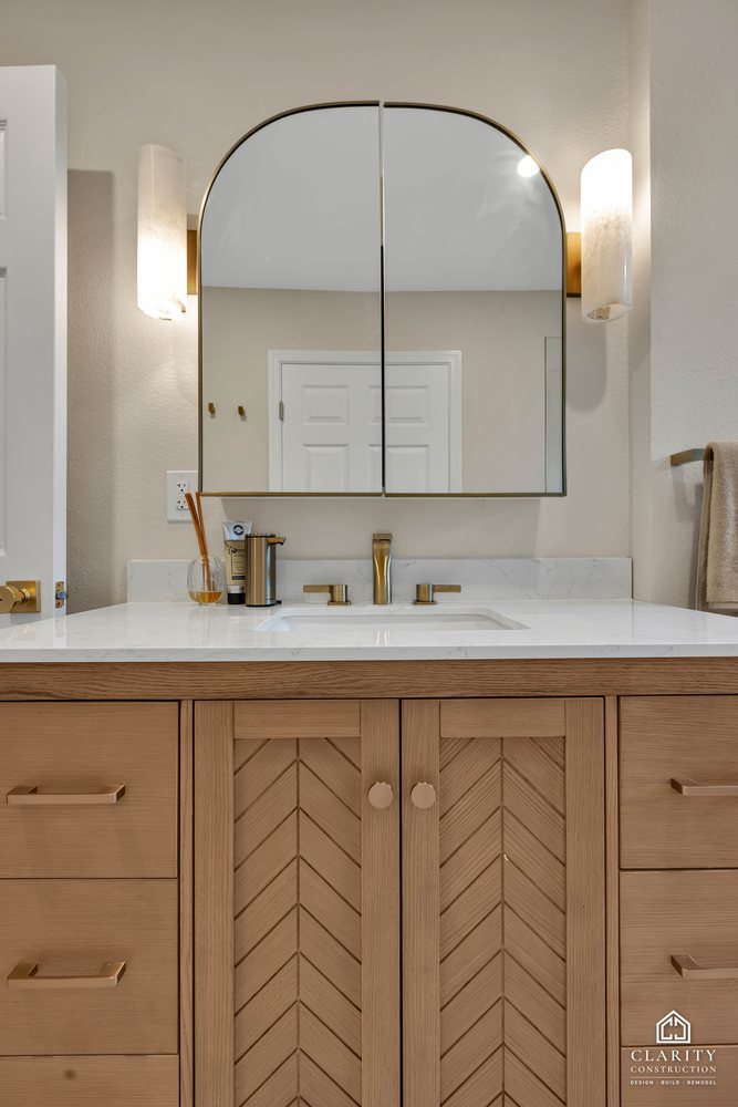Hall bath: chevron-front oak vanity with an arched medicine cabinet