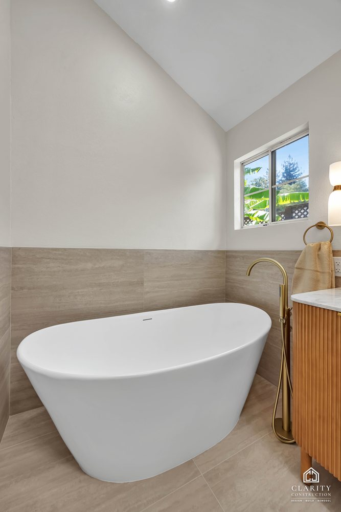 Primary bath: freestanding tub with a brass floor-mounted filler