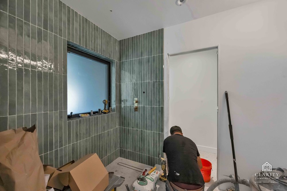 In progress: floors, lighting and the green-tiled bathroom going in at the San Francisco whole home remodel