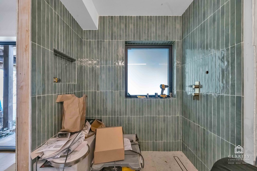 In progress: floors, lighting and the green-tiled bathroom going in at the San Francisco whole home remodel