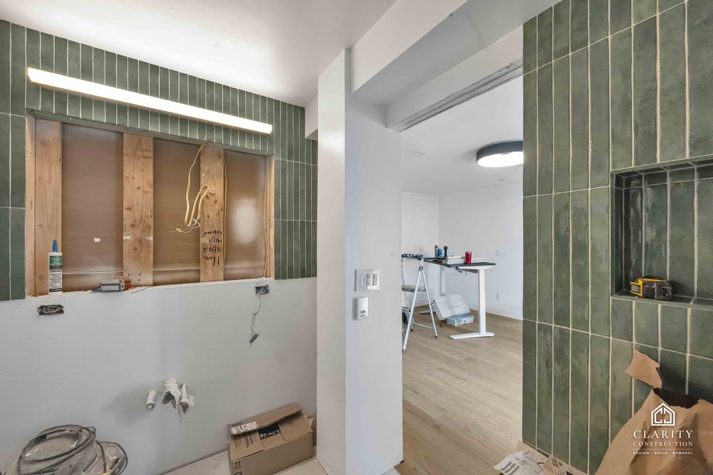 In progress: floors, lighting and the green-tiled bathroom going in at the San Francisco whole home remodel