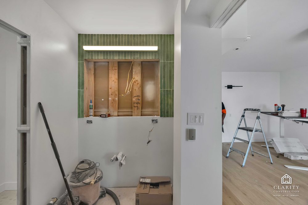 In progress: floors, lighting and the green-tiled bathroom going in at the San Francisco whole home remodel
