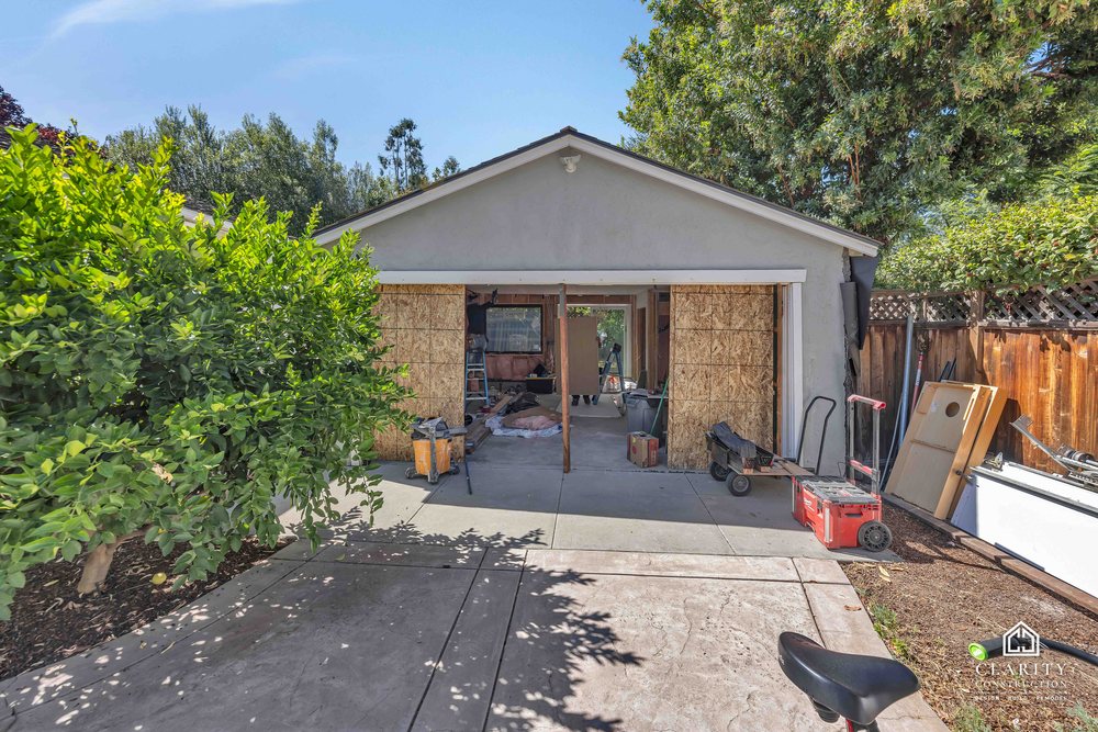 The detached garage in San Jose, seen from the yard, with insulation and drywall under way inside