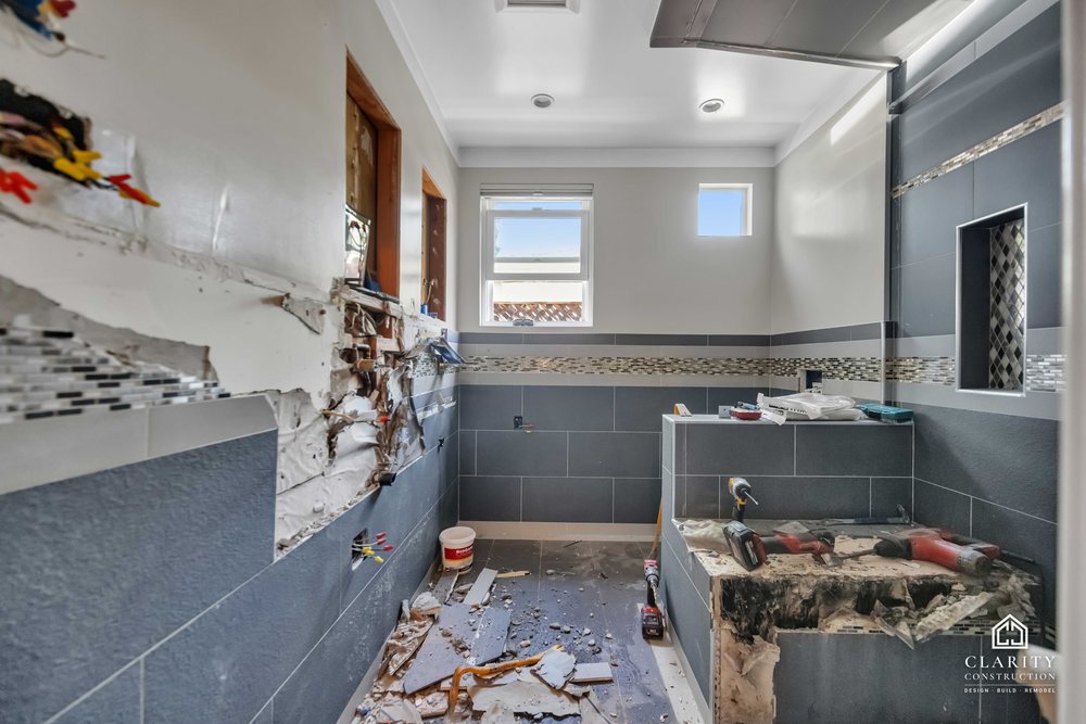In progress: gray tile and the mosaic band going up in the San Jose bathroom