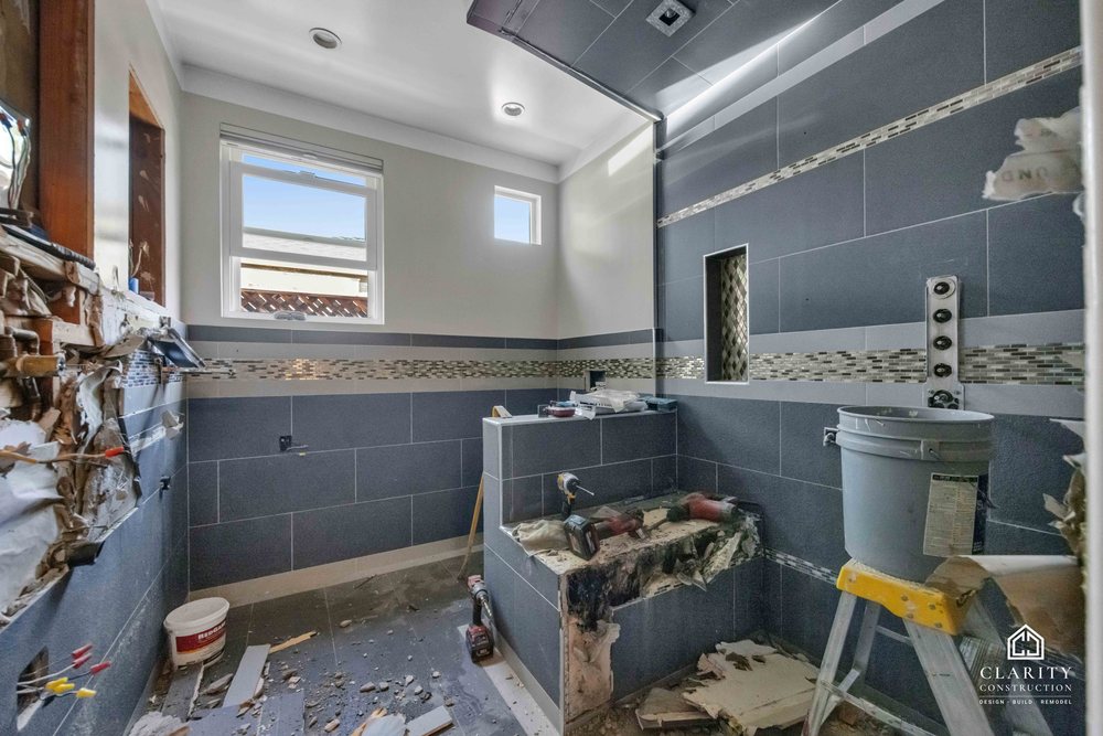 In progress: gray tile and the mosaic band going up in the San Jose bathroom
