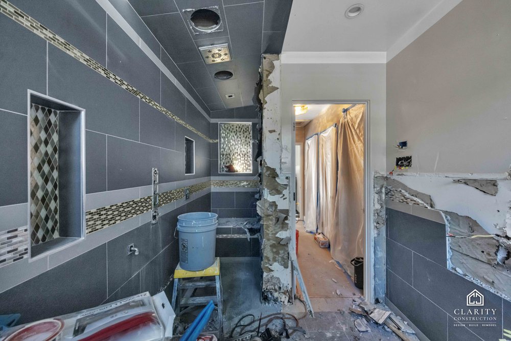 In progress: gray tile and the mosaic band going up in the San Jose bathroom