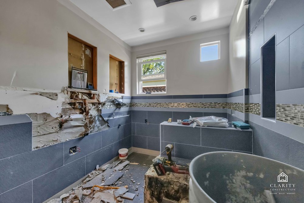 In progress: gray tile and the mosaic band going up in the San Jose bathroom