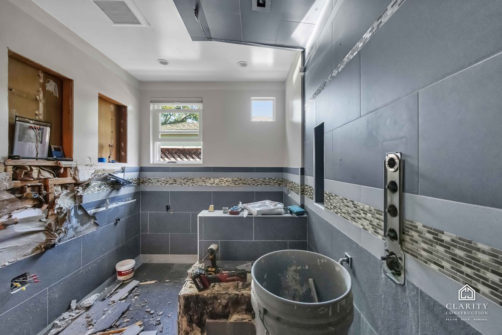 In progress: gray tile and the mosaic band going up in the San Jose bathroom