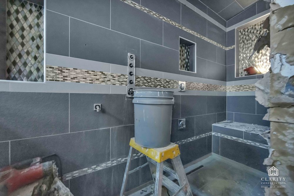 In progress: gray tile and the mosaic band going up in the San Jose bathroom