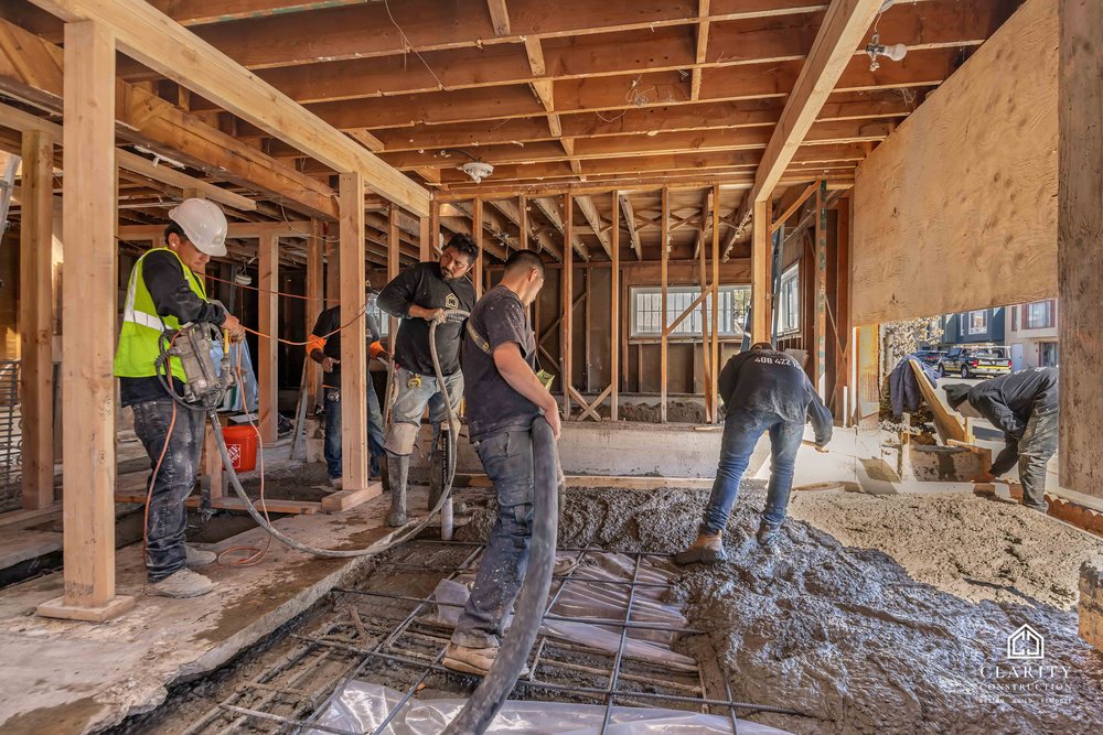 In progress: the crew placing the new concrete floor in the framed San Francisco house