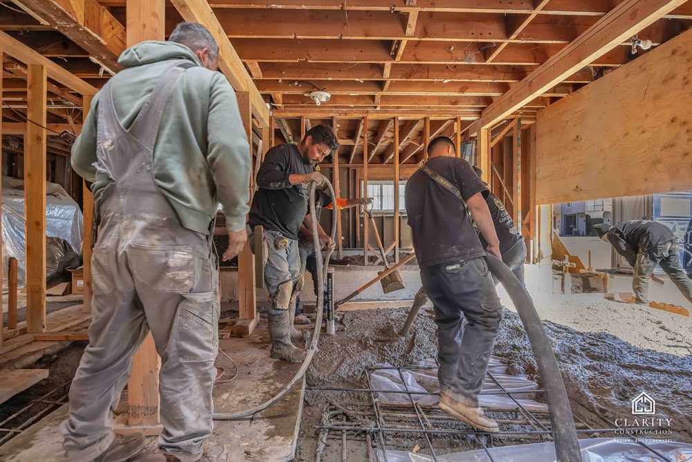 In progress: the crew placing the new concrete floor in the framed San Francisco house