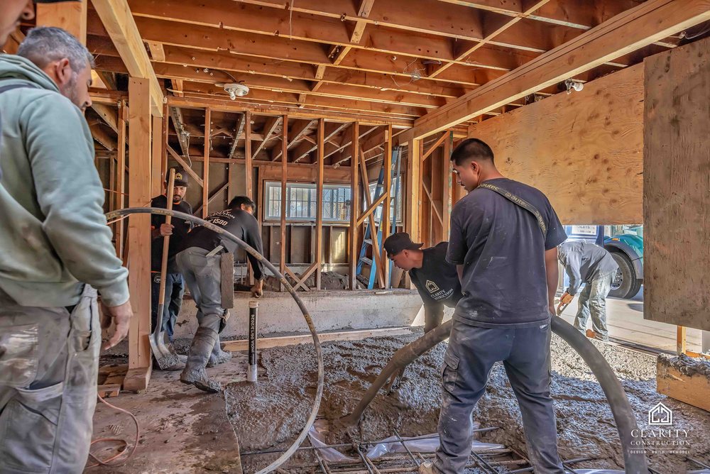 In progress: the crew placing the new concrete floor in the framed San Francisco house
