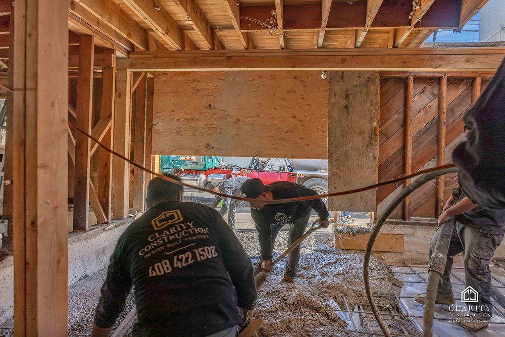In progress: the crew placing the new concrete floor in the framed San Francisco house